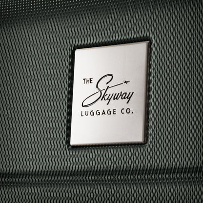 Close-up of Skyway logo plate on a Skyway Epic 2.0 Hardside Medium Check-in Spinner surface.