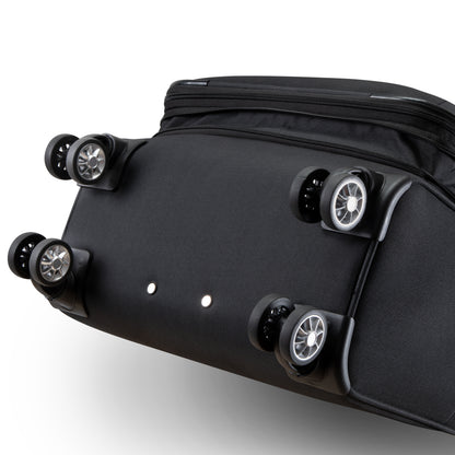Bottom view of a black Skyway Flair 2.0 3-Piece Luggage Set expandable suitcase showing four double-spinner wheels.