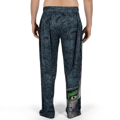 Person wears Brief Insanity Sesame Street Grouchy lounge pants with Oscar The Grouch and "GO AWAY!" graphics.