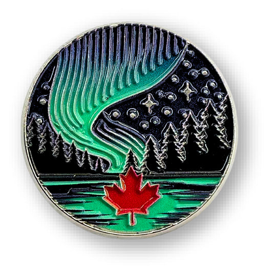 Product Image – Northern Icons Aurora Canada Enamel Pin features pine trees, a red maple leaf, stars, and lake at night.