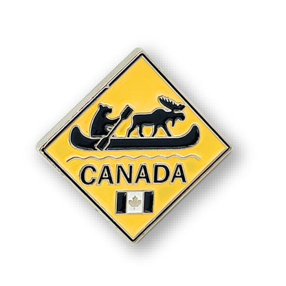 Northern Icons Canada Wilderness Crossing enamel pin features a bear, moose in canoe, "Canada," and tiny flag.