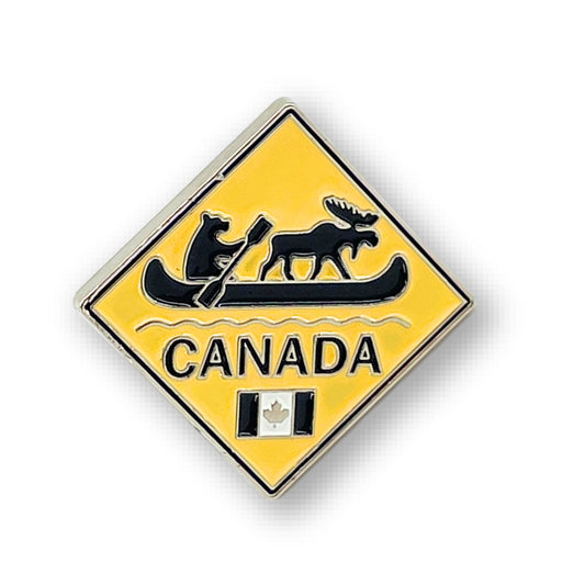 Product Image – Northern Icons Canada Wilderness Crossing enamel pin features a bear, moose in canoe, "Canada," and tiny flag.