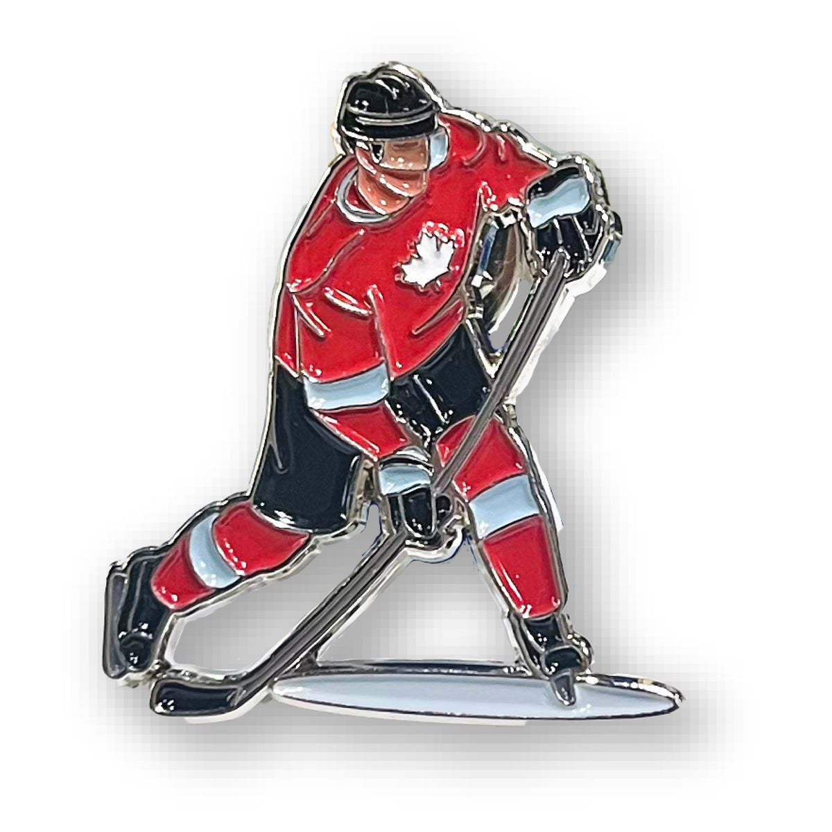 Northern Icons Maple Ice Hero Enamel Pin features a hockey player in a maple leaf jersey skating with stick and puck.