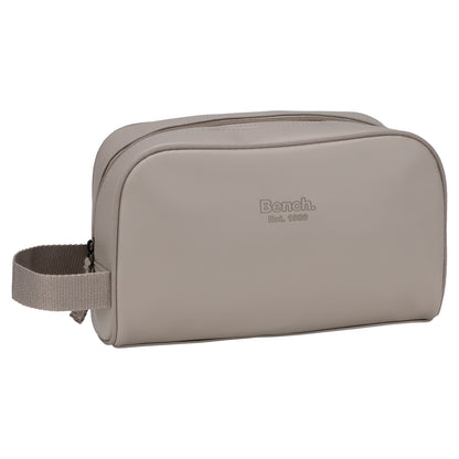 Bench Jayce Toiletry Bag: taupe faux leather, zip closure, side handle, "Bench. Est. 1989" embossed front.