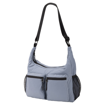 Bench Nylon Hobo Bag in blue with black adjustable strap and mesh side pockets.