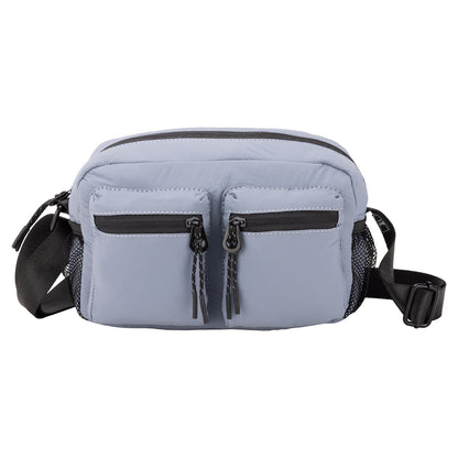 Bench Nylon Crossbody by Bench in light blue, features two zip pockets, mesh sides, and a black adjustable strap.