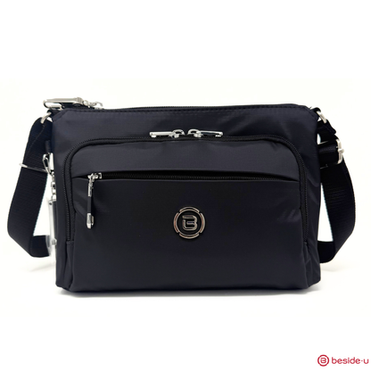 Beside-U Jubilee Crossbody: black anti-slash bag with RFID pocket, front zipper, and adjustable strap.