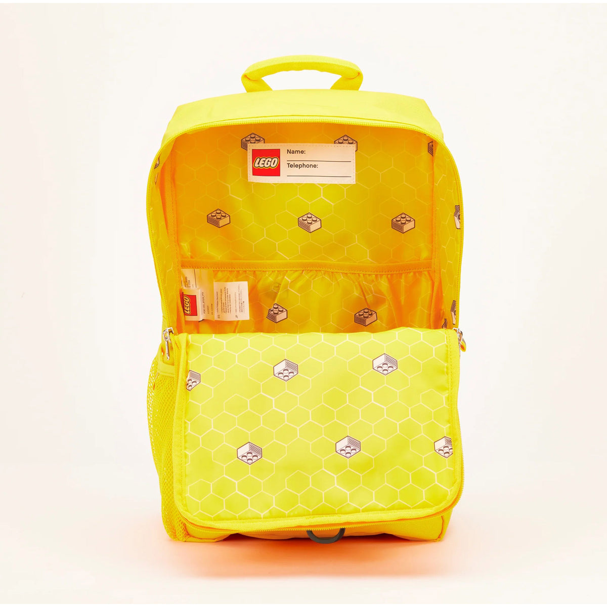 Bright yellow LEGO® Brick Backpack - ONLINE ONLY with a honeycomb-lined interior and a name tag.