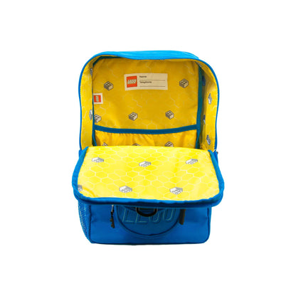 LEGO® Brick Backpack - ONLINE ONLY: open blue brick-shaped bag with a yellow, patterned interior and contact tag.