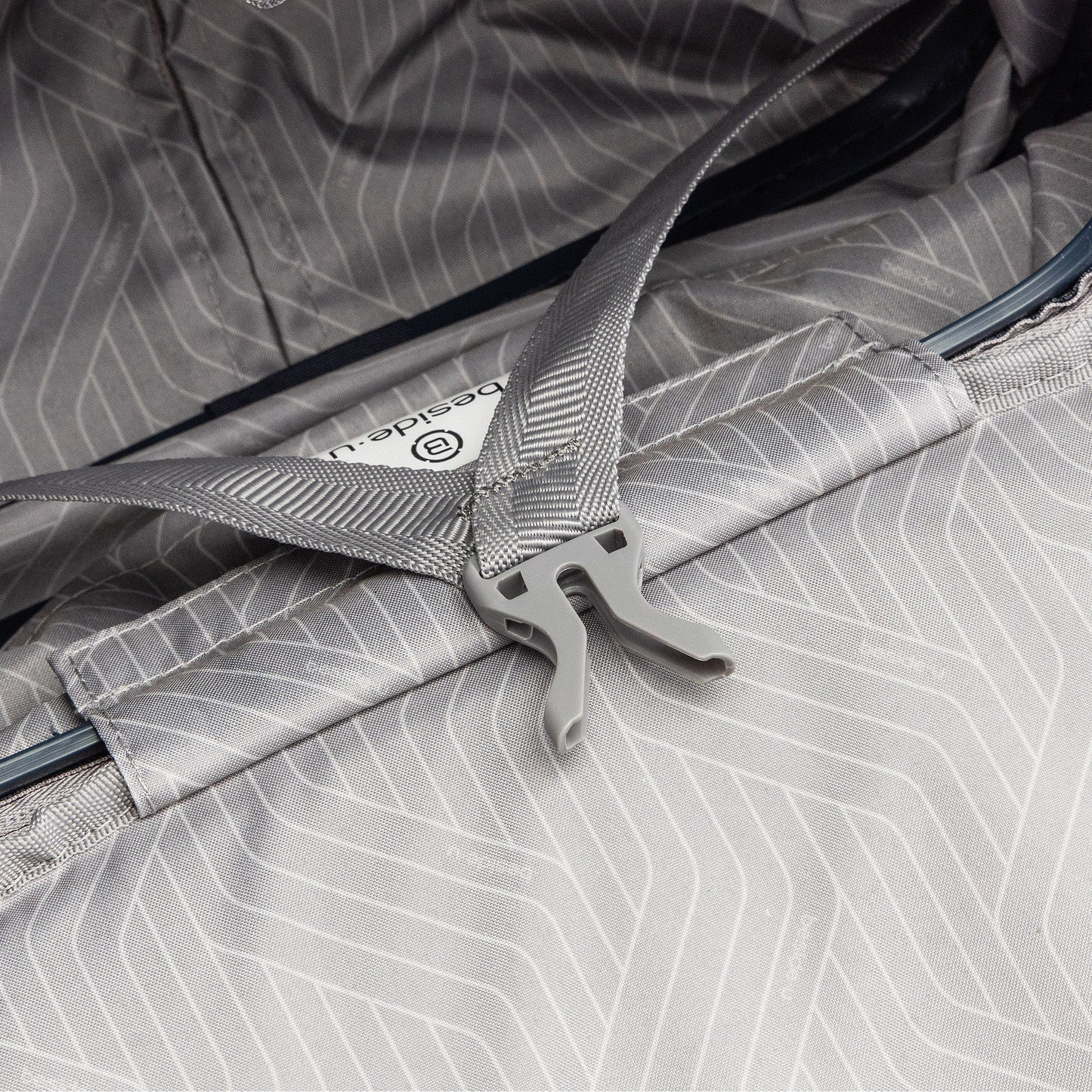 Close-up of a gray buckle, like an anti-theft zipper on the Beside-U Posh Voyage 20" Carry-on luggage.