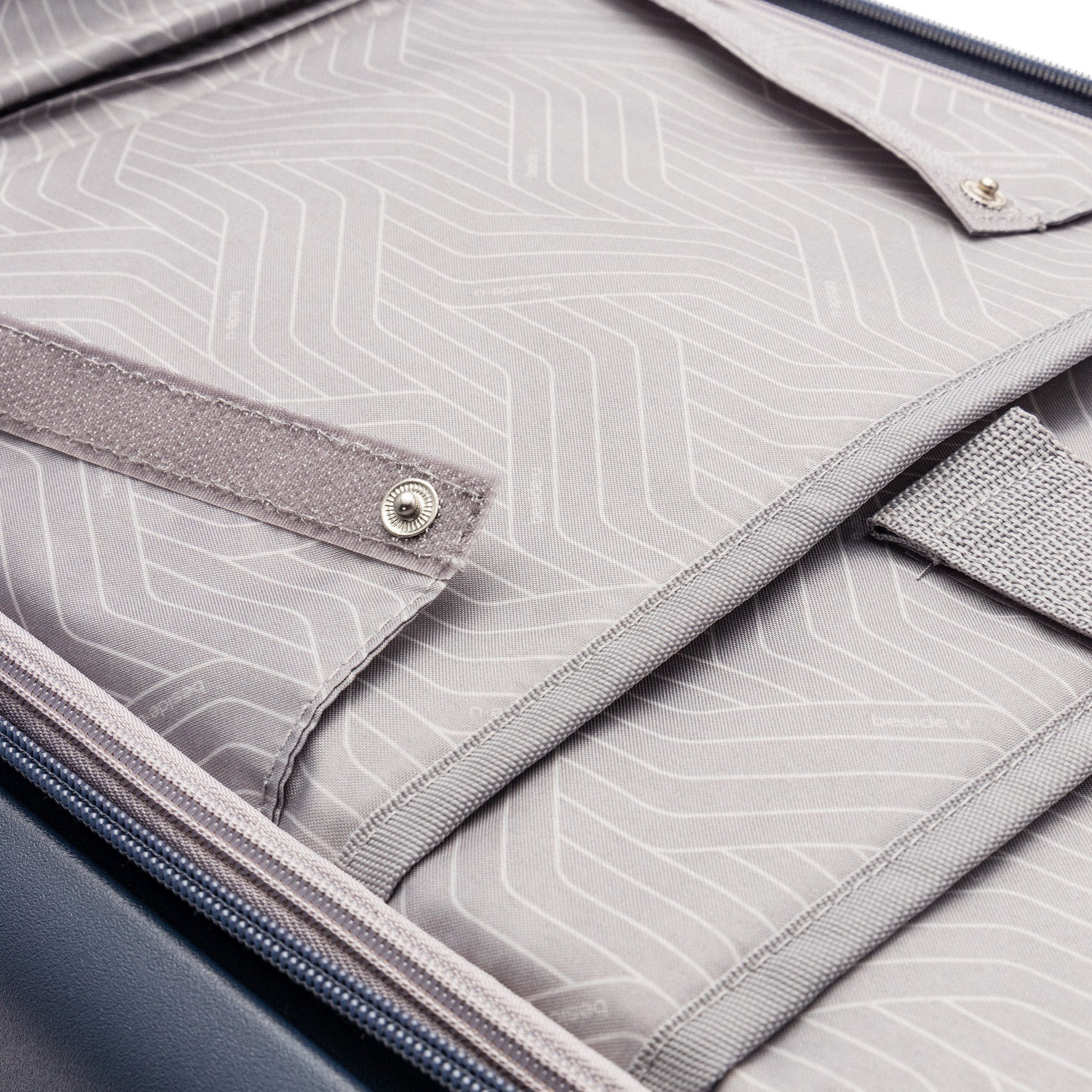Close-up of Beside-U Posh Voyage 20" Carry-on interior with fabric lining, anti-theft zipper, and compartments.