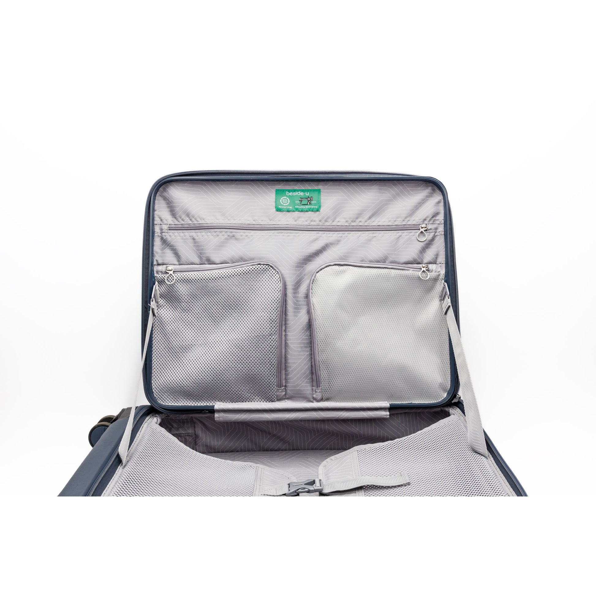 The Beside-U Posh Voyage 24" features top-loading access, interior mesh pockets, straps, and a green lid label.