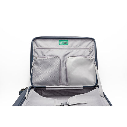 Beside-U Posh Voyage 28" luggage features a light gray interior, mesh pockets, and a green lid label.
