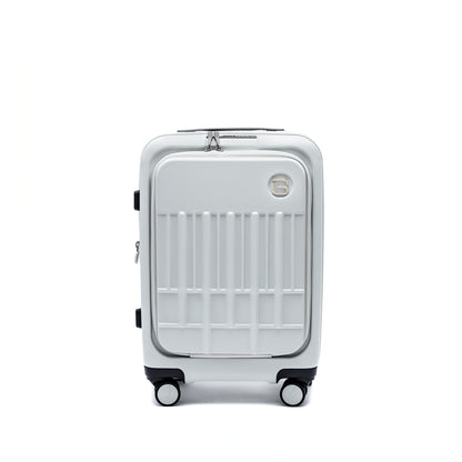 The Beside-U Posh Voyage 20" silver polycarbonate carry-on features four wheels and a top handle.
