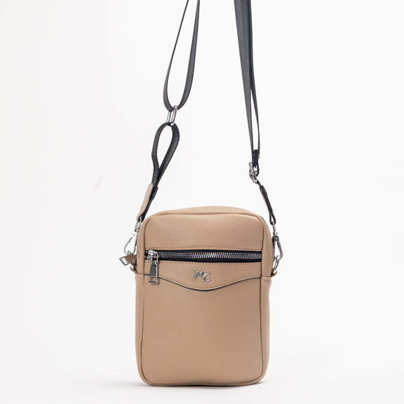 The Miss Caprice Compact Crossbody is a beige bag with black strap—perfect for stylish, practical everyday travel.