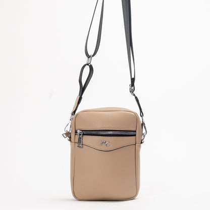 The Miss Caprice Compact Crossbody is a beige bag with black strap—perfect for stylish, practical everyday travel.