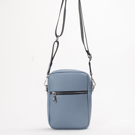 Miss Caprice Compact Crossbody: a light blue rectangular bag with front zipper, ideal for daily use and travel.