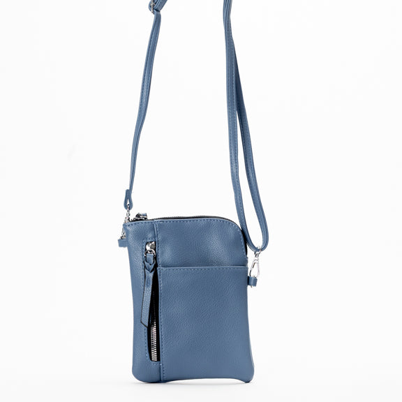 The Miss Caprice Small Crossbody, by Miss Caprice, features multiple zip pockets and hangs against a white background.