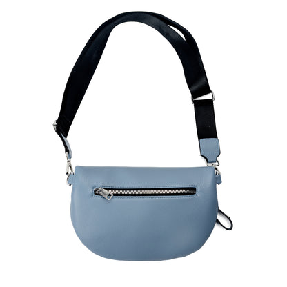 Miss Caprice Waist/Crossbody Bag in denim blue with adjustable black nylon strap for convenient hands-free style, back view.