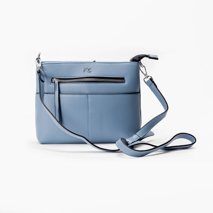 Miss Caprice Front Zipper Crossbody: light blue leather bag with adjustable strap and front zipper pocket.