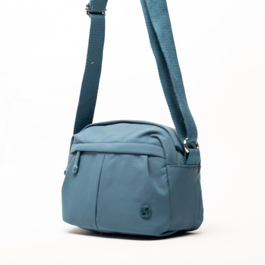 Product Image – Miss Caprice Compact Nylon Crossbody in blue with front zipper pocket, adjustable strap, on a white background.