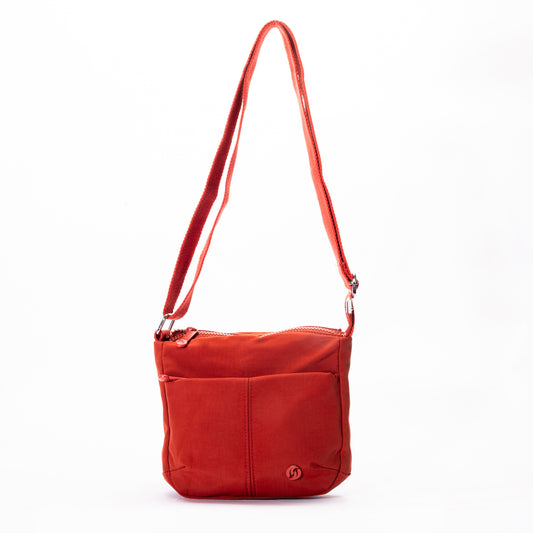 Product Image – Miss Caprice Small Nylon Crossbody: red, long strap, zip top, front pocket, circular logo.