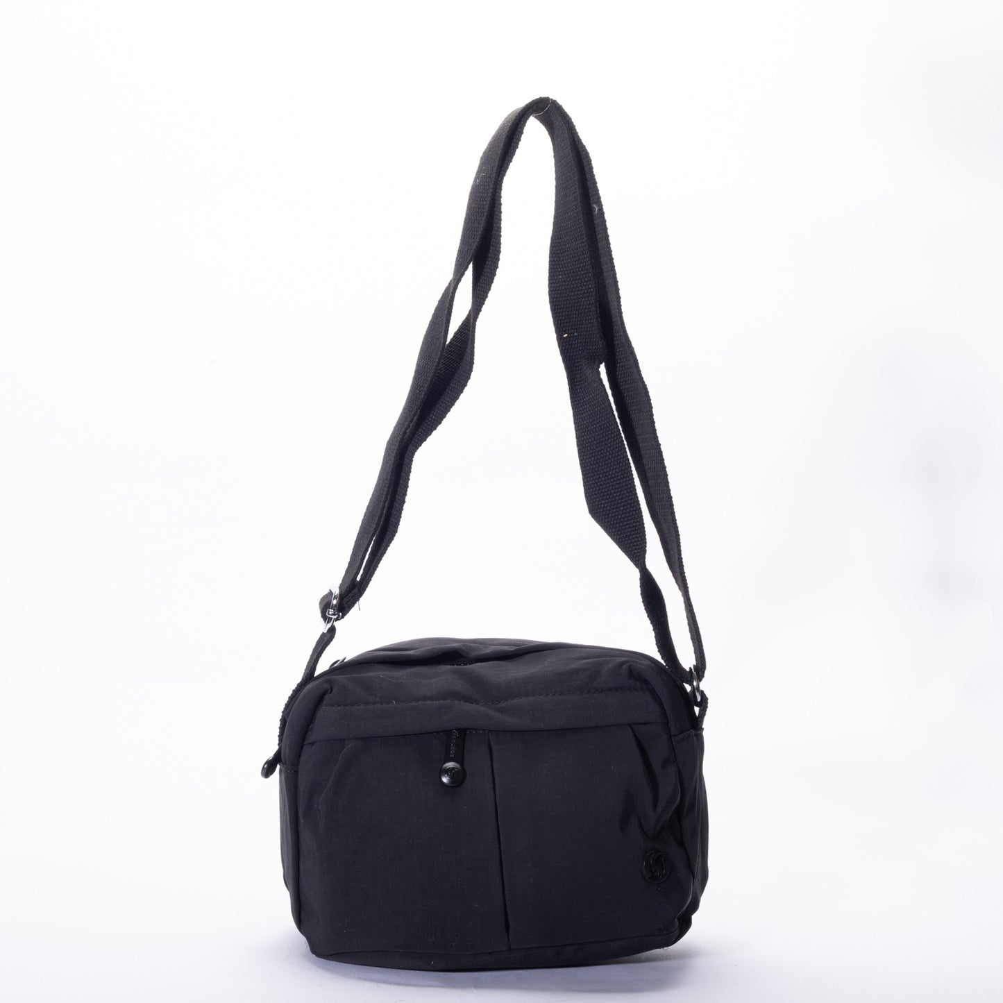 The Miss Caprice Compact Nylon Crossbody features a front pocket and adjustable strap, shown on a white background.
