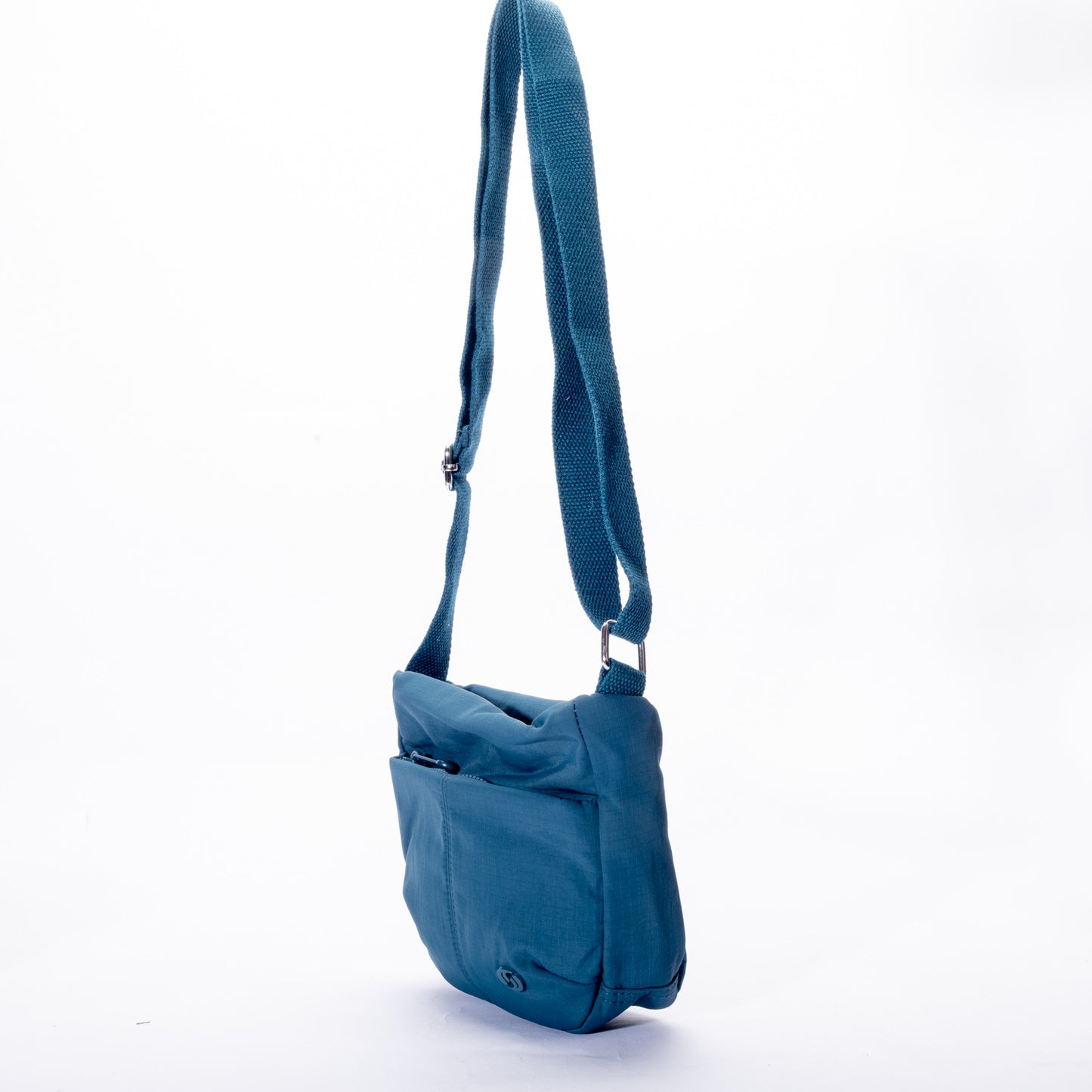 The Miss Caprice Small Nylon Crossbody is shown in blue with a long adjustable strap on a white background.