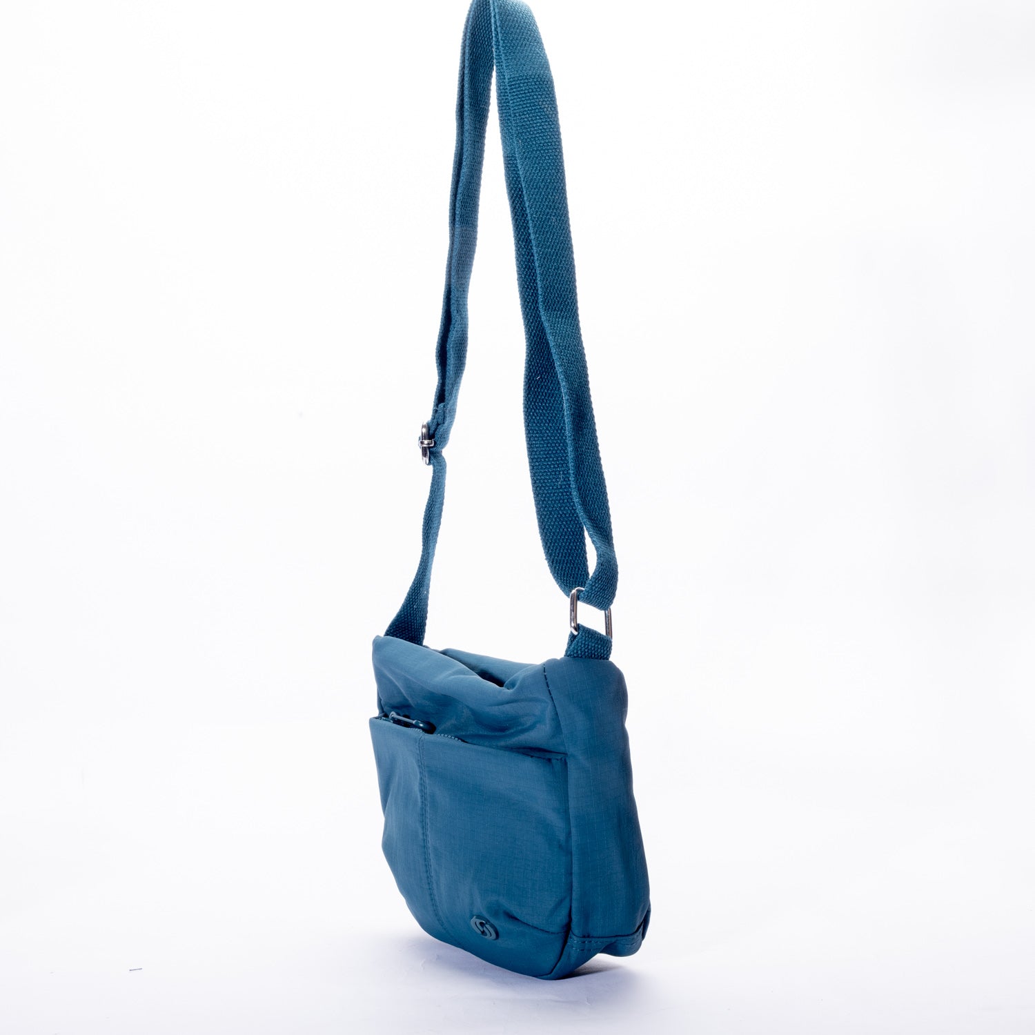 The Miss Caprice Small Nylon Crossbody is shown in blue with a long adjustable strap on a white background.