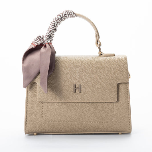 Product Image – Miss Caprice Hope Handbag: Beige faux leather, scarf-wrapped top handle, metallic "H" on front flap.