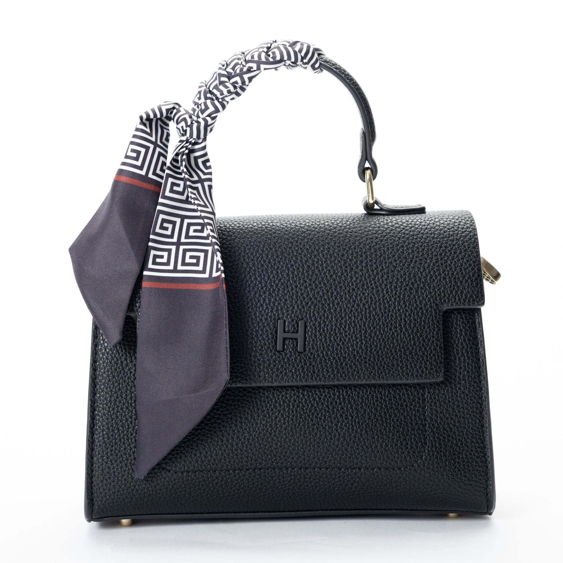 Miss Caprice Hope Handbag in black faux leather, adorned with a patterned scarf, shown on a white background.