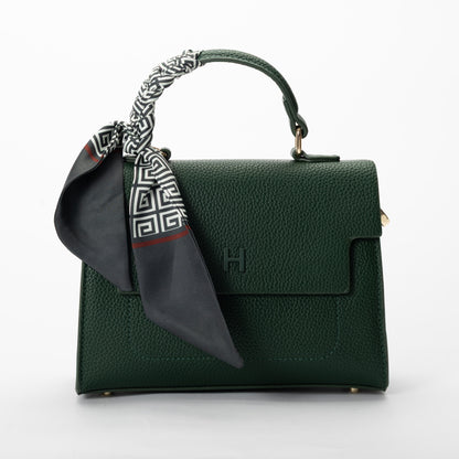 Miss Caprice Hope Handbag in dark green faux leather, styled with a black-and-white scarf for added flair.