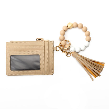 Miss Caprice Cardholder with Bracelet Keychain, clear ID slot, and tassel in beige faux leather.