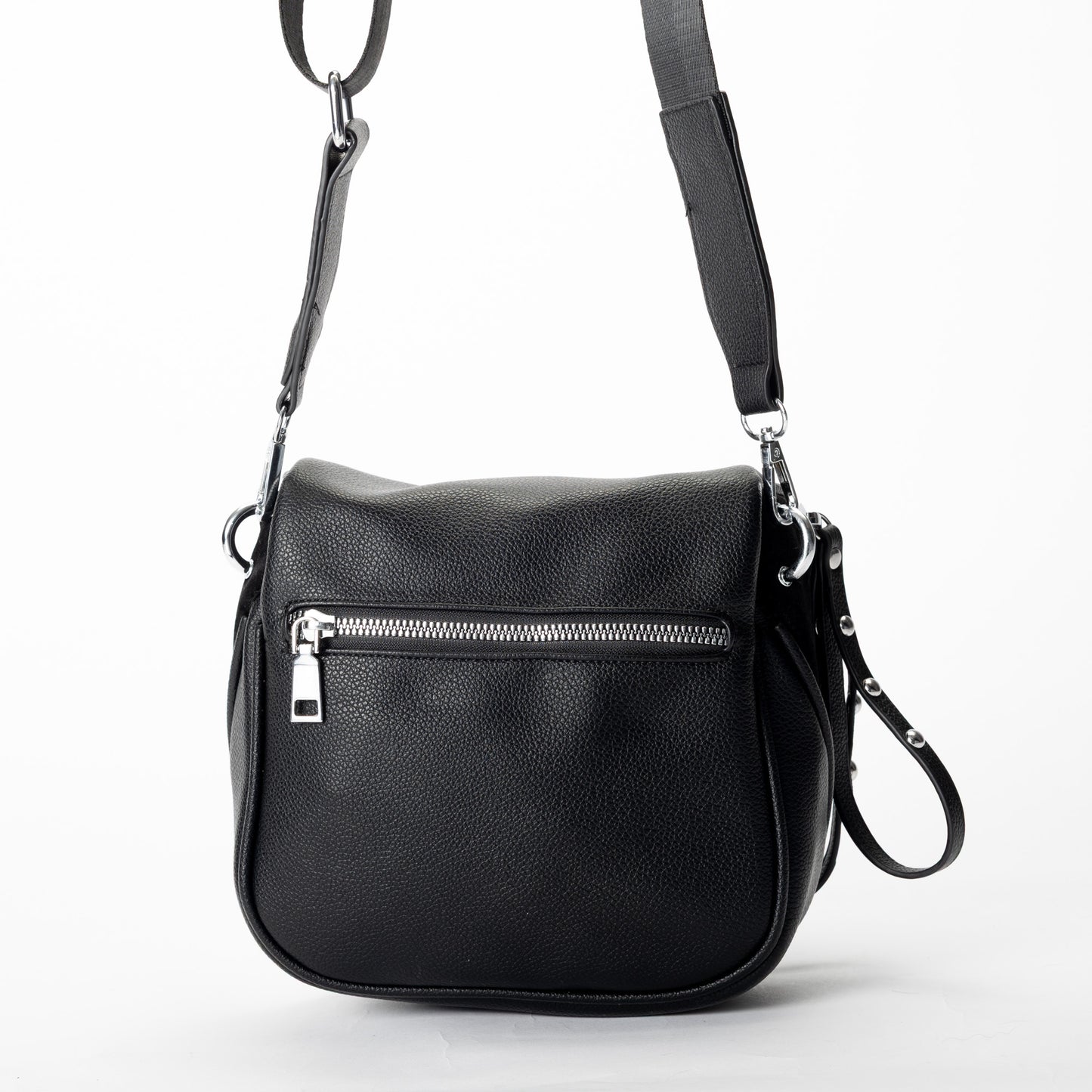 Miss Caprice Clara Crossbody bag in black faux leather, with zip pockets and adjustable strap, shown on white.