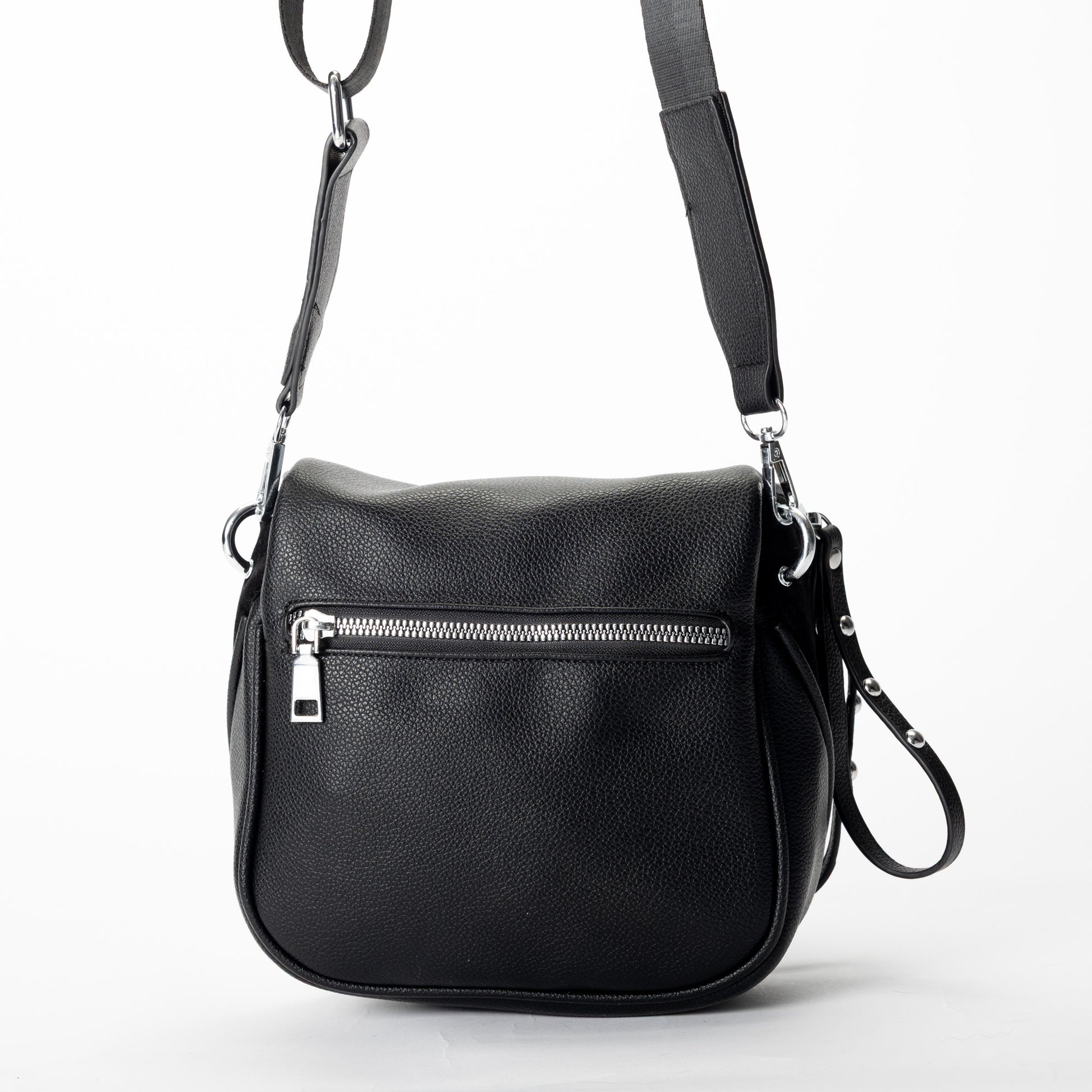 Miss Caprice Clara Crossbody bag in black faux leather, with zip pockets and adjustable strap, shown on white.