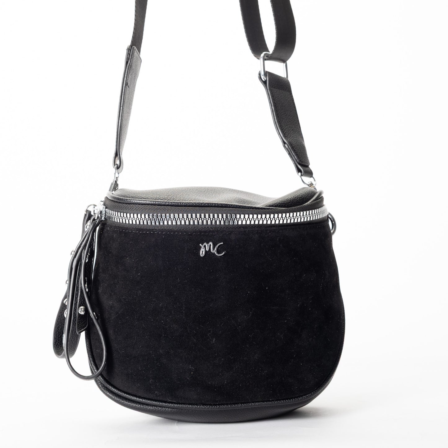 Miss Caprice Clara Crossbody: black faux suede with silver zipper, leather strap, and front "MC" logo.
