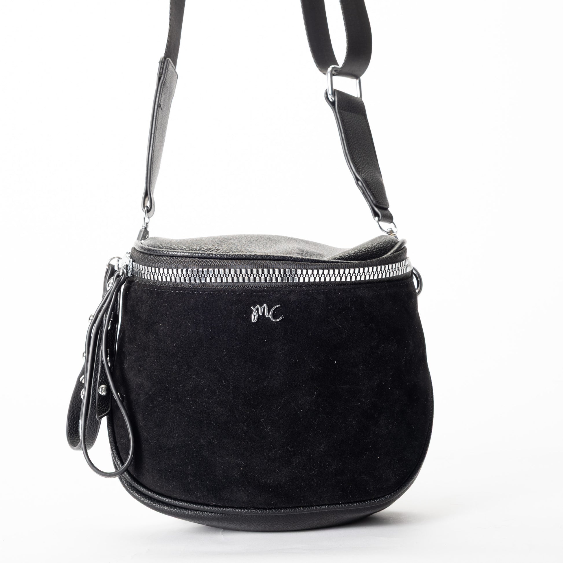Miss Caprice Clara Crossbody: black faux suede with silver zipper, leather strap, and front "MC" logo.