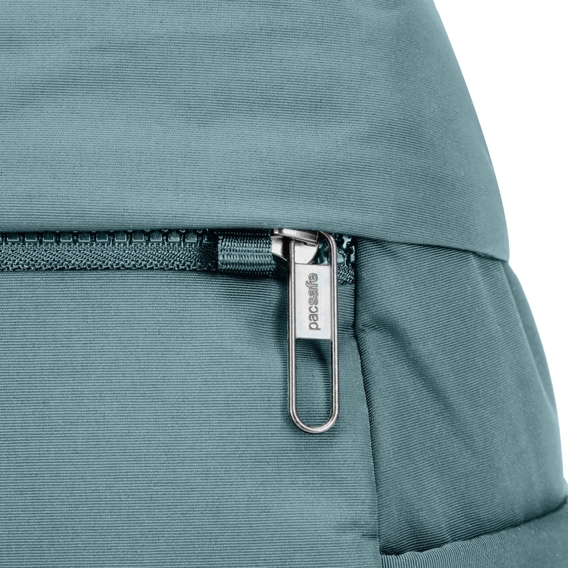 Close up of zipper pull secured through loop on fresh mint Pacsafe® CX Anti-theft 8L Backpack Petite