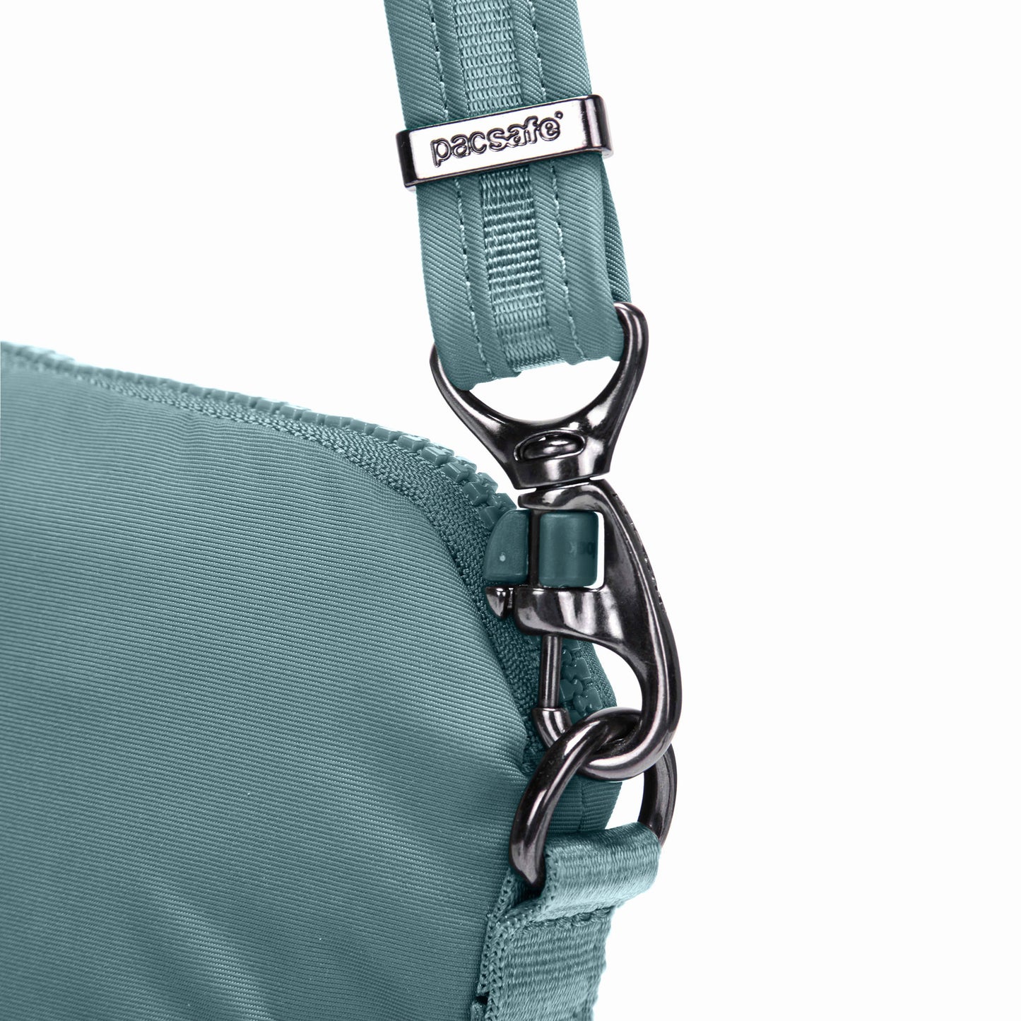 Close up of turn n lock strap clip on the fresh mint Pacsafe® CX Anti-Theft Convertible Crossbody