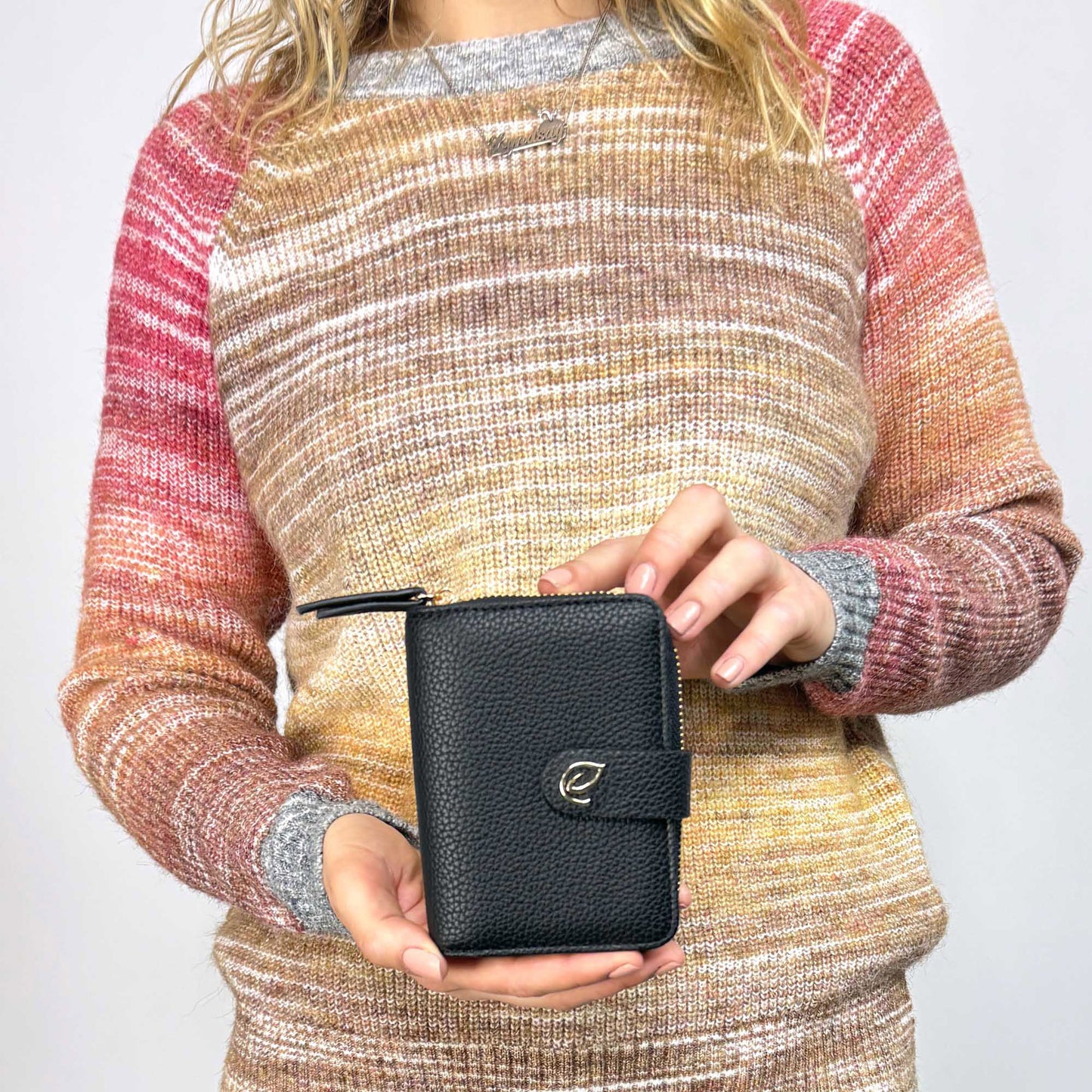 Woman holding the Espe Cora Small Wallet in black, front view