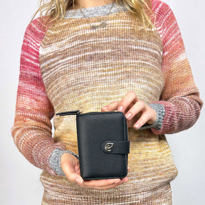 Woman holding the Espe Cora Small Wallet in black, front view