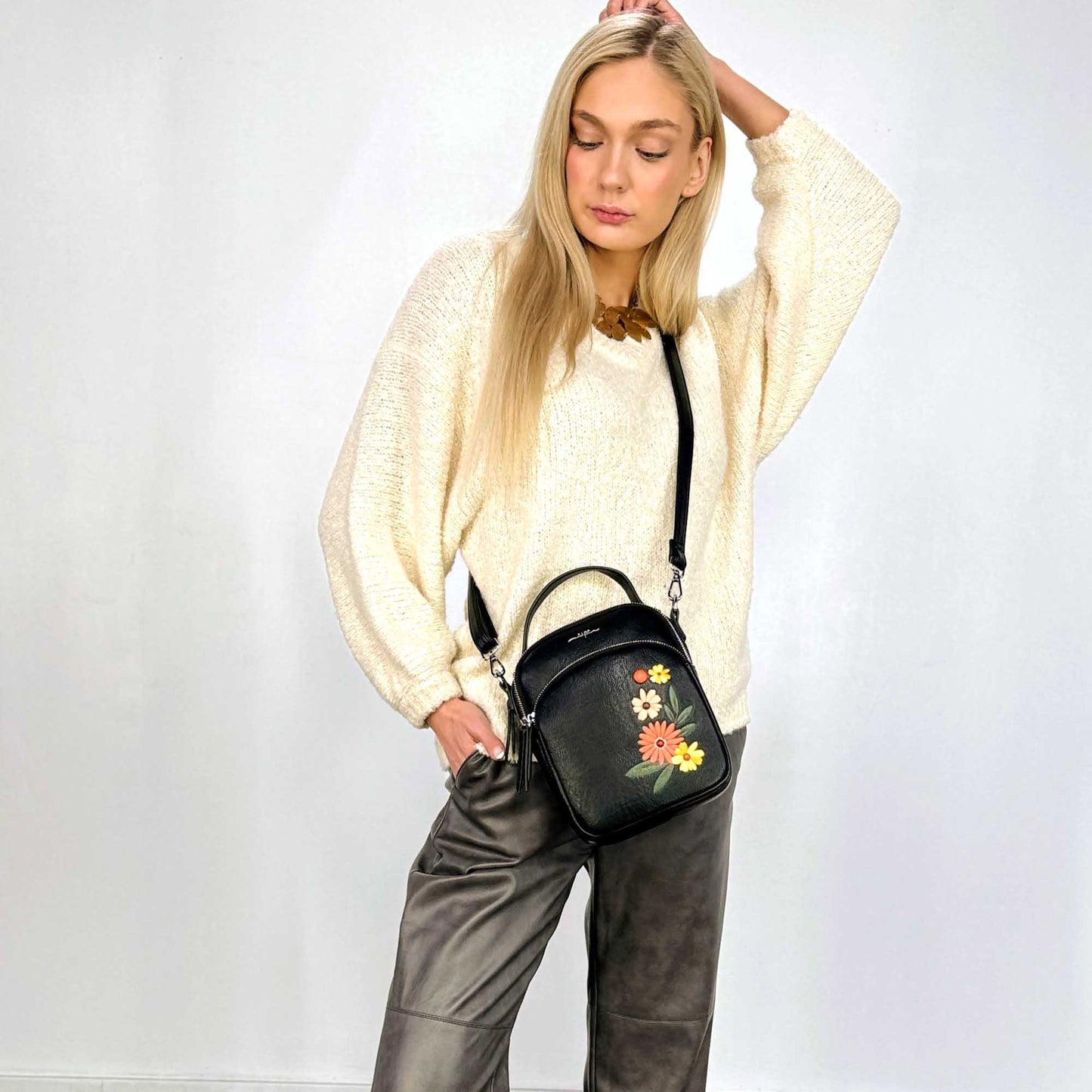 Woman wearing white sweater and black Espe Daliah Crossbody