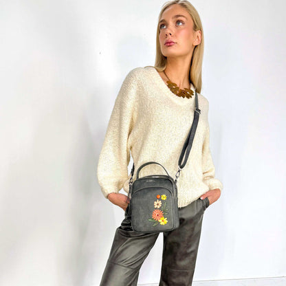 Woman wearing a white sweater and the grey Espe Daliah Crossbody