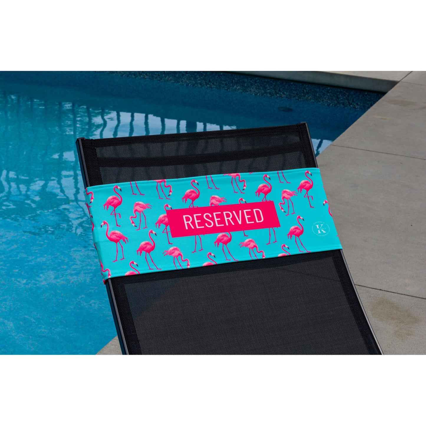 Pink flamingos on a turquoise background K5 Reserved Chair Sleeve, placed on a poolside chair.