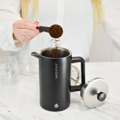 Matte black Grosche Dublin French press with mesh filter and coffee grounds
