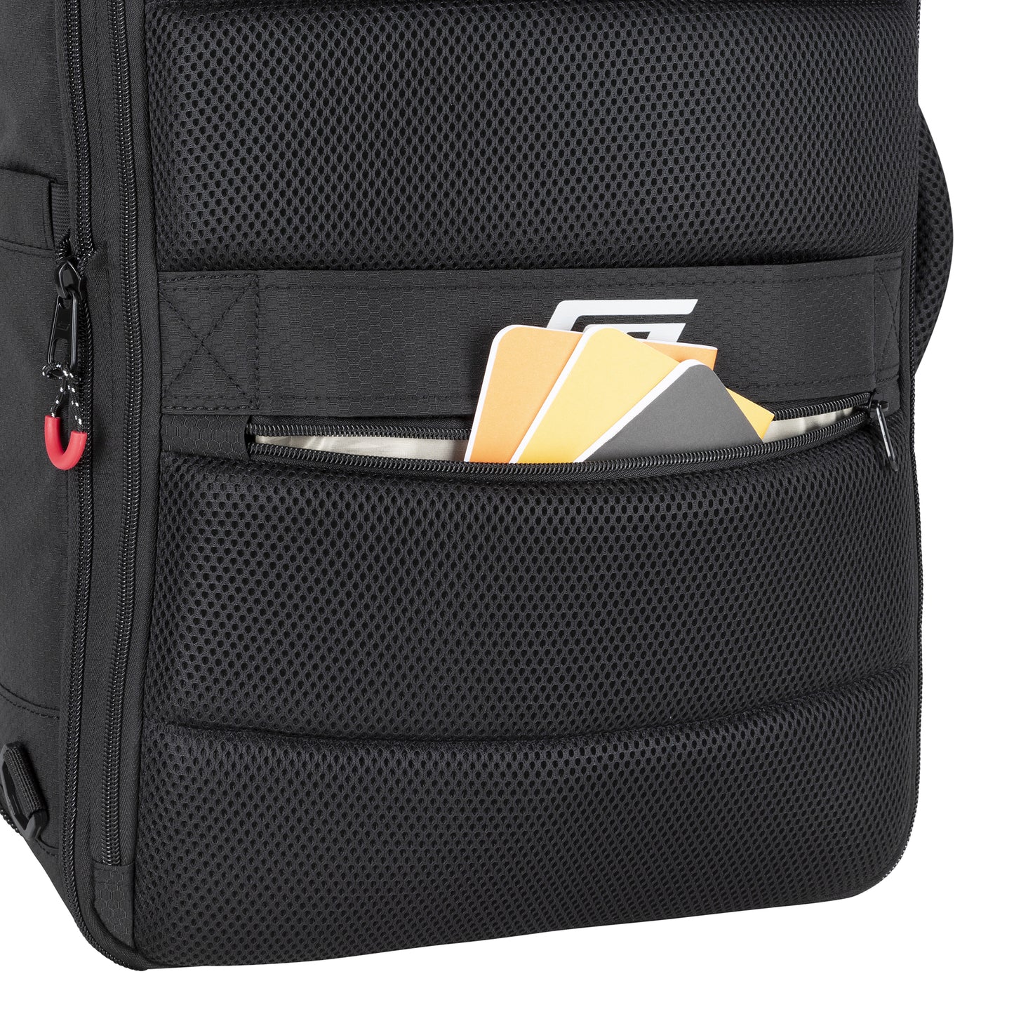 A close-up of the Graphite Metamorph Convertible Travel Backpack pocket with notebooks, a folder, and a document.