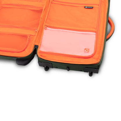 The Graphite Metamorph 21" Carry-on Wheeled Duffle - ONLINE ONLY is designed for outdoor adventures with its orange zippered compartments inside. This lightweight carry-on, crafted from water-resistant materials, ensures your belongings remain safe and dry.