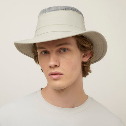 A young person faces forward in a Tilley LTM5 Airflo® Hat and light shirt against a plain background.