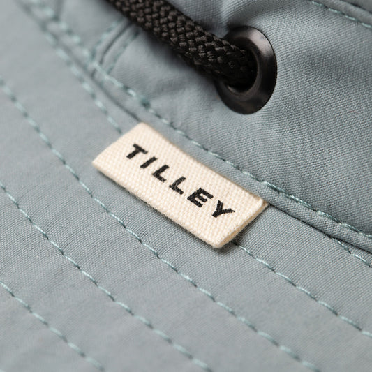Product Image – Close-up of light grey Tilley T5 Adventure Ultralight Hat with UPF 50+ and black drawstring.
