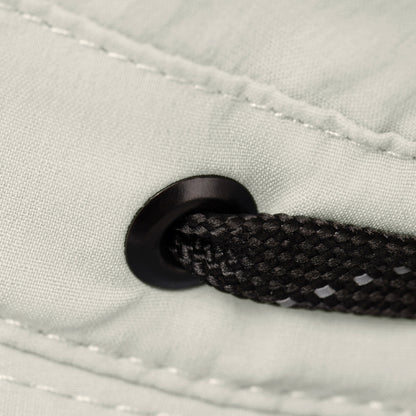Close-up of a black drawstring and grommet on the Tilley T5 Adventure Ultralight Hat’s UPF 50+ fabric.